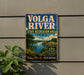 A vintage-style sign for the Volga River State Recreation Area in Iowa, featuring a scenic landscape with a river, mountains, and a bridge.