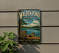 A vintage-style metal sign for Walden Pond, a state reserve in Massachusetts, with a lake and trees in the background.
