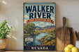 A vintage-style sign for Walker River State Recreation Area in Nevada, featuring a scenic illustration of the river surrounded by mountains and lush vegetation.