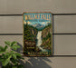 A vintage metal sign for Wallace Falls State Park in Washington, featuring a scenic illustration of the waterfall surrounded by pine trees and mountains.