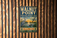 A vintage metal sign for Walnut Point State Fish & Wildlife Area in Illinois, featuring an illustration of birds and a sunset over a lake.