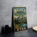 A vintage-style metal sign for Wasatch Mountain State Park in Utah, featuring a scenic mountain landscape with a lake and pine trees.