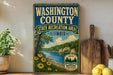 A vintage-style sign for Washington County, Illinois, featuring a scenic landscape with a river, trees, and flowers.