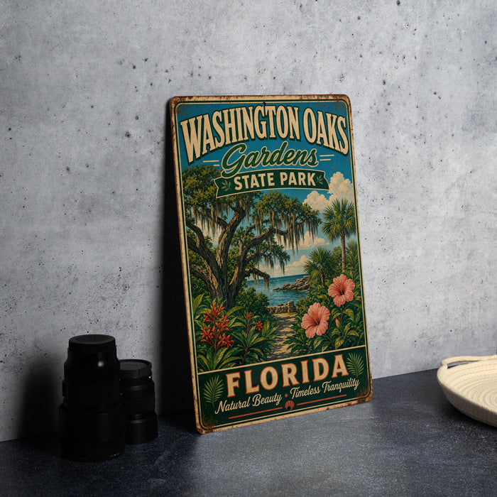 A vintage-style metal sign for Washington Oak Gardens State Park in Florida, featuring a tropical landscape with palm trees, flowers, and a body of water.