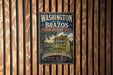 A vintage-style metal sign for Washington on the Brazos State Historic Site, featuring a house and a wagon wheel, is displayed on a wooden wall.
