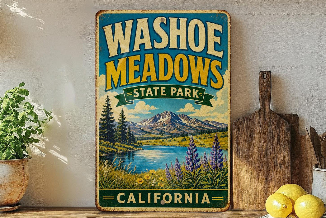 A vintage-style metal sign for Washoe Meadows State Park in California, featuring a scenic landscape with mountains, a lake, and wildflowers.