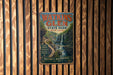 A vintage metal sign for Watkins Glen State Park in New York, featuring a scenic waterfall and nature trails.