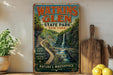 A vintage-style metal sign for Watkins Glen State Park in New York, featuring a scenic waterfall and lush greenery.