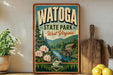 A vintage-style poster advertising Watoga State Park in West Virginia, featuring a scenic landscape with a river, pine trees, and a wooden cabin.