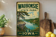 A vintage-style sign for Waubonsie State Park in Iowa, featuring a scenic landscape with a river, cliffs, and trees.