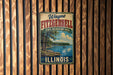 A vintage metal sign for Wayne Fitzgerald State Recreation Area in Illinois, featuring a scenic landscape with a lake and trees.