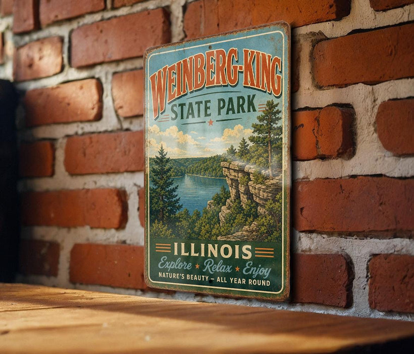 A vintage-style metal sign for Weinberg-King State Park in Illinois, featuring a scenic landscape with a lake and mountains.