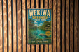 A vintage metal sign for Wekiwa Springs State Park, featuring a scenic image of the springs and surrounding landscape.