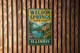 A vintage-style metal sign for Welton Springs State Park in Illinois, featuring a scenic illustration of the park's natural surroundings.