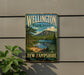 A vintage metal sign for Wellington State Park in New Hampshire, featuring a scenic landscape with pine trees, a lake, and mountains.