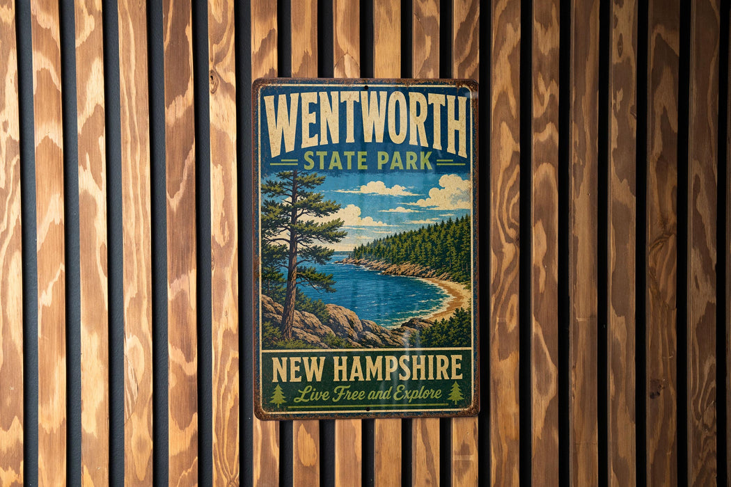A vintage metal sign for Wentworth State Park in New Hampshire, featuring a scenic landscape with a lake, mountains, and pine trees.