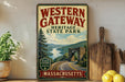 A vintage-style sign for Western Gateway Heritage State Park in Massachusetts, featuring a scenic image of a winding road surrounded by mountains and forests.