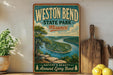 A vintage-style poster of the Mississippi River at the end of the bend in Missouri, with the text "WESTON BEND STATE PARK - MISSOURI" prominently displayed.