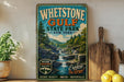A vintage-style metal sign for Whestone Gulf State Park, featuring a scenic image of a waterfall surrounded by pine trees.