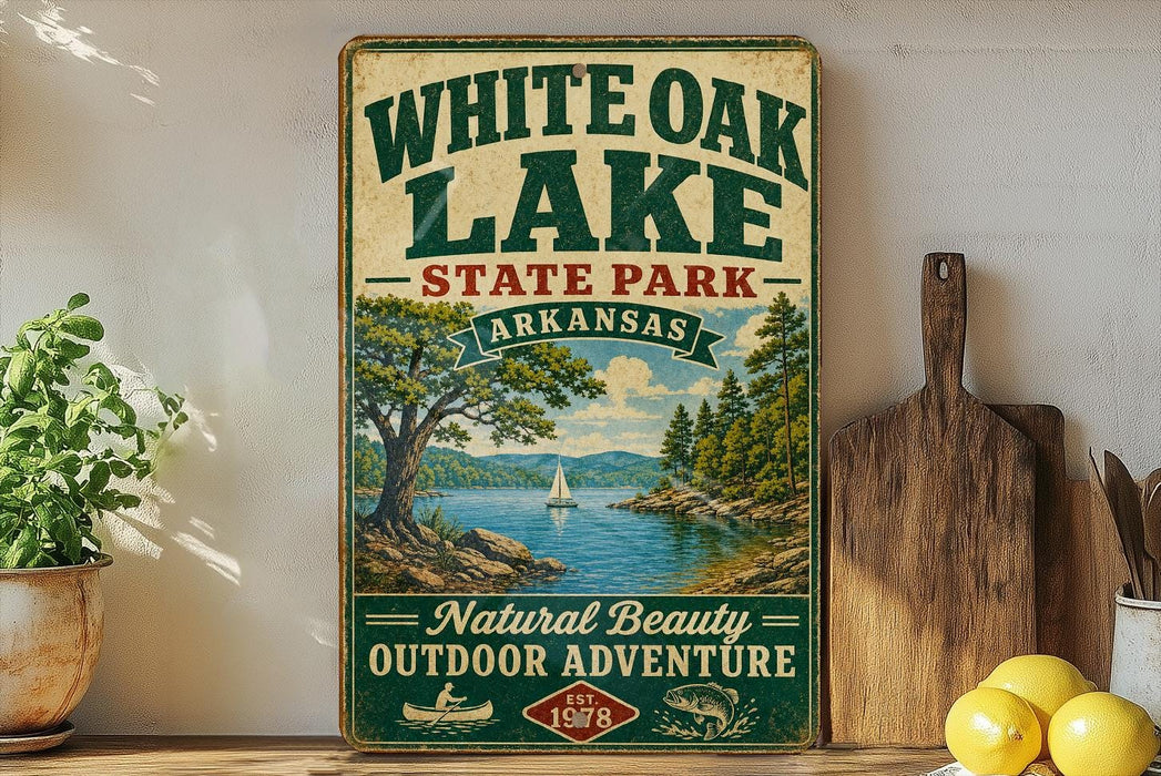 A vintage-style sign for White Oak Lake State Park in Arkansas, featuring a scenic illustration of a lake surrounded by trees and mountains.