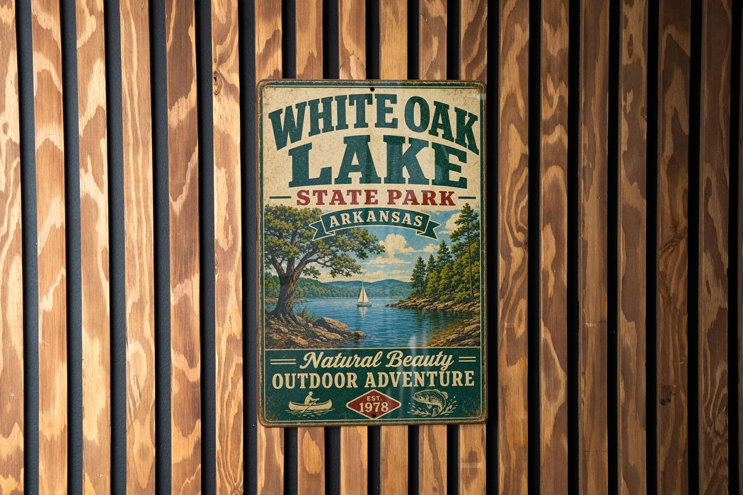 A vintage-style metal sign for White Oak Lake State Park in Arkansas, featuring a scenic image of the lake and surrounding landscape.