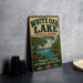 A vintage-style sign for White Oak Lake State Park in Arkansas, featuring a scenic illustration of a lake, trees, and a sailboat.