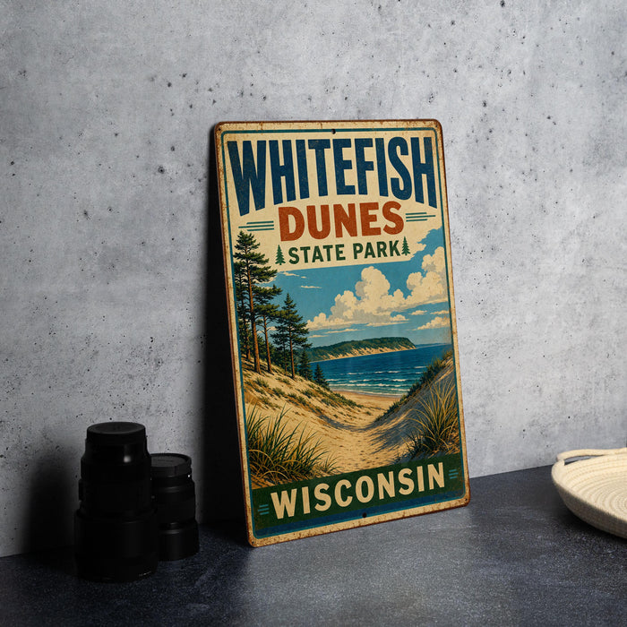 A vintage-style sign for Whitefish Dunes State Park in Wisconsin, featuring a scenic landscape with a beach, dunes, and mountains.