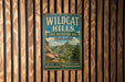 A vintage metal sign for Wildcat Hills, a state recreation area in Nebraska, is displayed on a wooden wall.