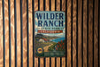 A vintage metal sign for Wilder Ranch State Park, California, featuring a scenic illustration of the park's landscape.