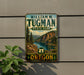A vintage-style metal sign for William M. Tugman State Park in Oregon, featuring a scenic landscape with mountains, a river, and pine trees.