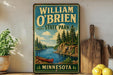 A vintage-style sign for William O'Brien State Park in Minnesota, featuring a scenic illustration of a lake, pine trees, and a canoe.