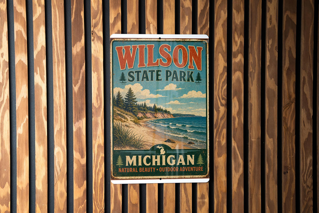A vintage-style metal sign for Wilson State Park, featuring a scenic landscape with a beach, mountains, and pine trees.