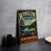 A vintage-style metal sign for Winslow State Park, New Hampshire, featuring a scenic landscape with pine trees, a lake, and mountains.