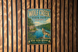 A vintage-style metal sign for Wolf Creek State Park in Illinois, featuring a wolf standing on a rock overlooking a river.