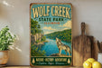 A vintage-style sign for Wolf Creek State Park in Illinois, featuring a wolf howling at the water and surrounded by lush greenery.