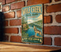 A vintage-style metal sign for Wolf Creek State Park in Illinois, featuring a wolf howling at the water and surrounded by trees.
