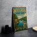 A vintage-style metal sign for Wolf Creek State Park in Illinois, featuring an illustration of a wolf standing on a rock overlooking a river.