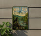 A vintage-style metal sign for Wolf Run State Park in Ohio, featuring a wolf standing on a rock overlooking a river surrounded by trees.