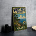 A vintage-style metal sign for Wolf's Neck Woods State Park in Maine, featuring a scenic illustration of the park's landscape.
