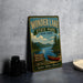 A vintage-style metal sign for Wonder Lake State Park in New York, featuring a scenic illustration of a lake, mountains, and a canoe.