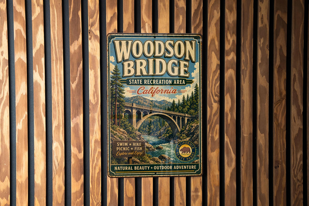 A vintage-style metal sign for the Woodson Bridge, a California state recreation area, is displayed on a wooden wall.