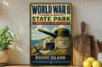 a vintage World War II commemorative sign for Rhode Island State Park, with a large cannon and a wooden paddle on a shelf.