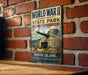 A vintage World War II commemorative sign for Rhode Island State Park, featuring a cannon and a message about defending democracy.