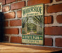 A vintage-style metal sign for the Wormsloe Historic Site in State Park, Georgia, featuring a path lined with trees and a gate leading to the entrance.