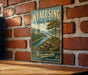 A vintage-style metal sign for Wyalusing State Park in Wisconsin, featuring a scenic landscape with a river and mountains.