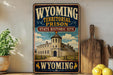 A vintage-style sign for the Wyoming Territorial Prison State Historic Site, featuring an illustration of a castle-like building and the text "Wyoming" prominently displayed.