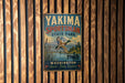 A vintage metal sign for Yakima Sportsman State Park, featuring a scenic image of ducks flying over a lake and mountains in the background.