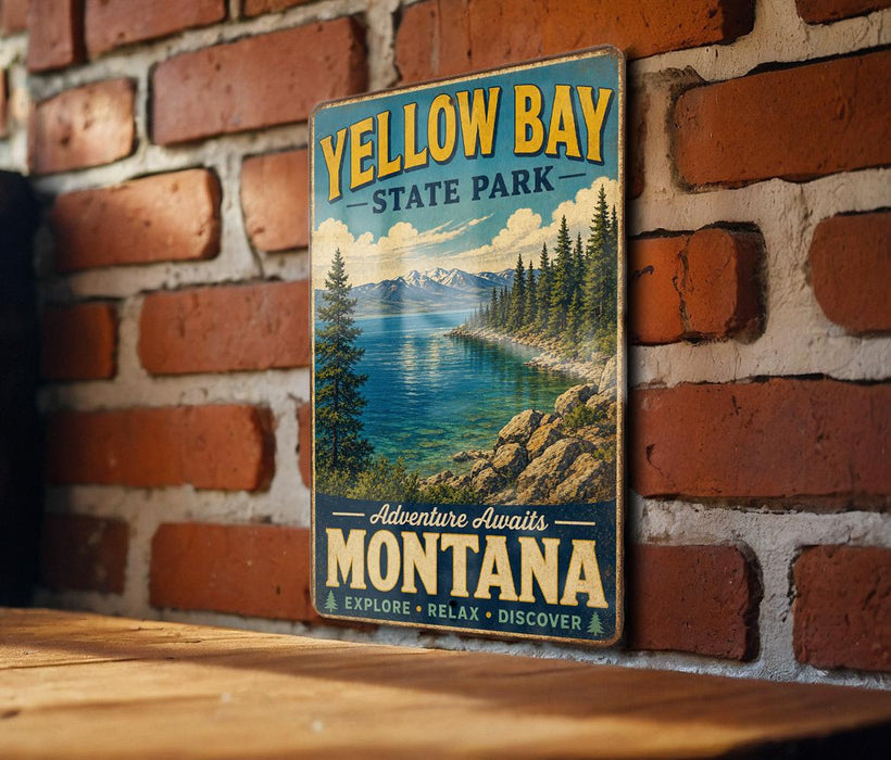 A vintage-style metal sign for Yellow Bay State Park in Montana, featuring a scenic landscape with a lake, mountains, and pine trees.