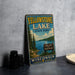 A vintage-style sign for Yellowstone Lake State Park in Wisconsin, featuring a scenic illustration of the lake surrounded by pine trees and mountains.