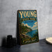 A vintage-style metal sign for Young State Park in Michigan, featuring a scenic landscape with a lake, mountains, and pine trees.